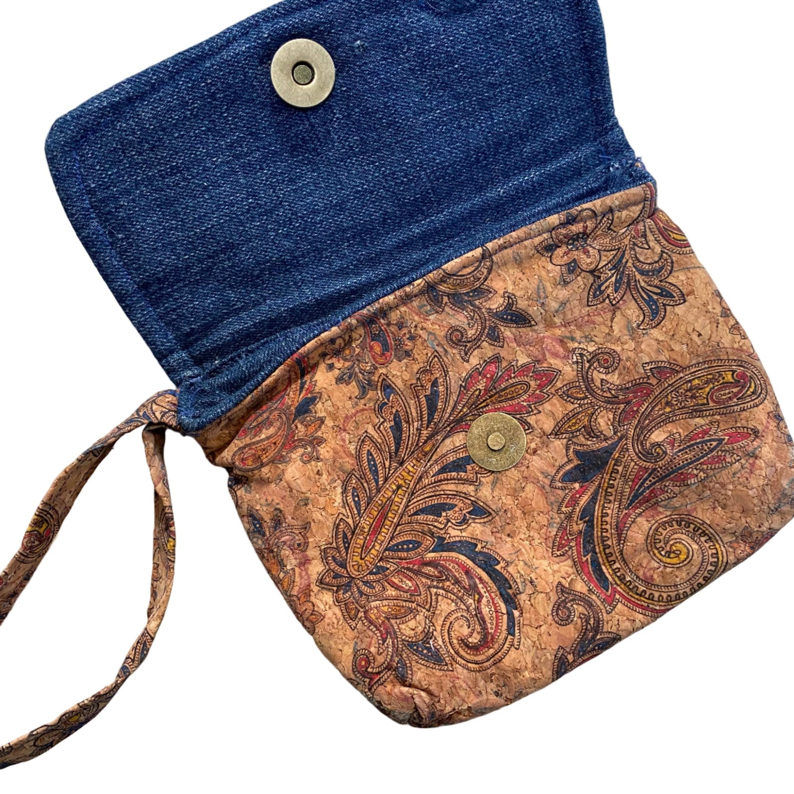 Transmutation clutch is made from recycled cork textile with paisley design. Has a small handle and is lined with denim.