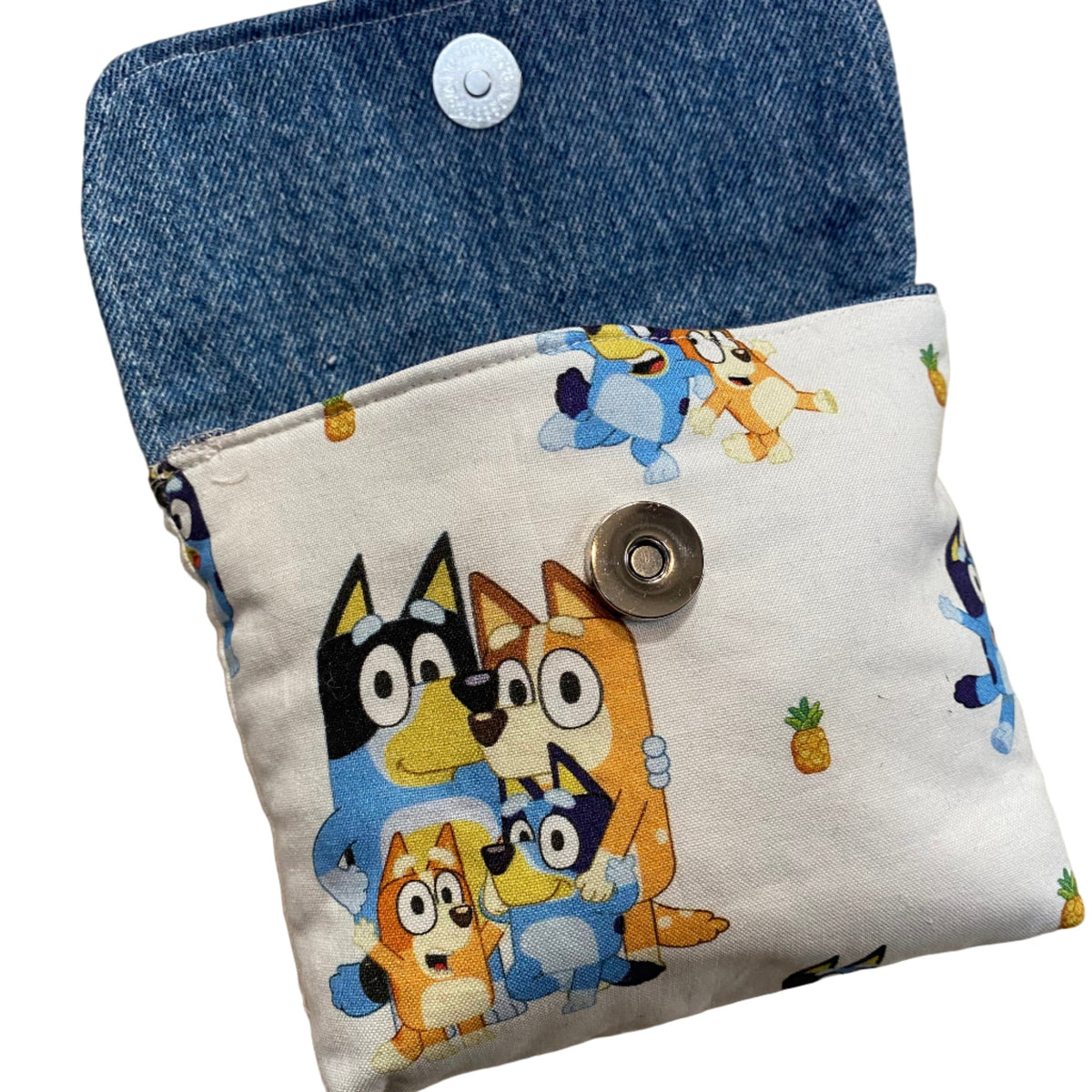 Transmutation - Bag - small clutch lined with old denim and outer layer with Bluey motif and a press stud clip.