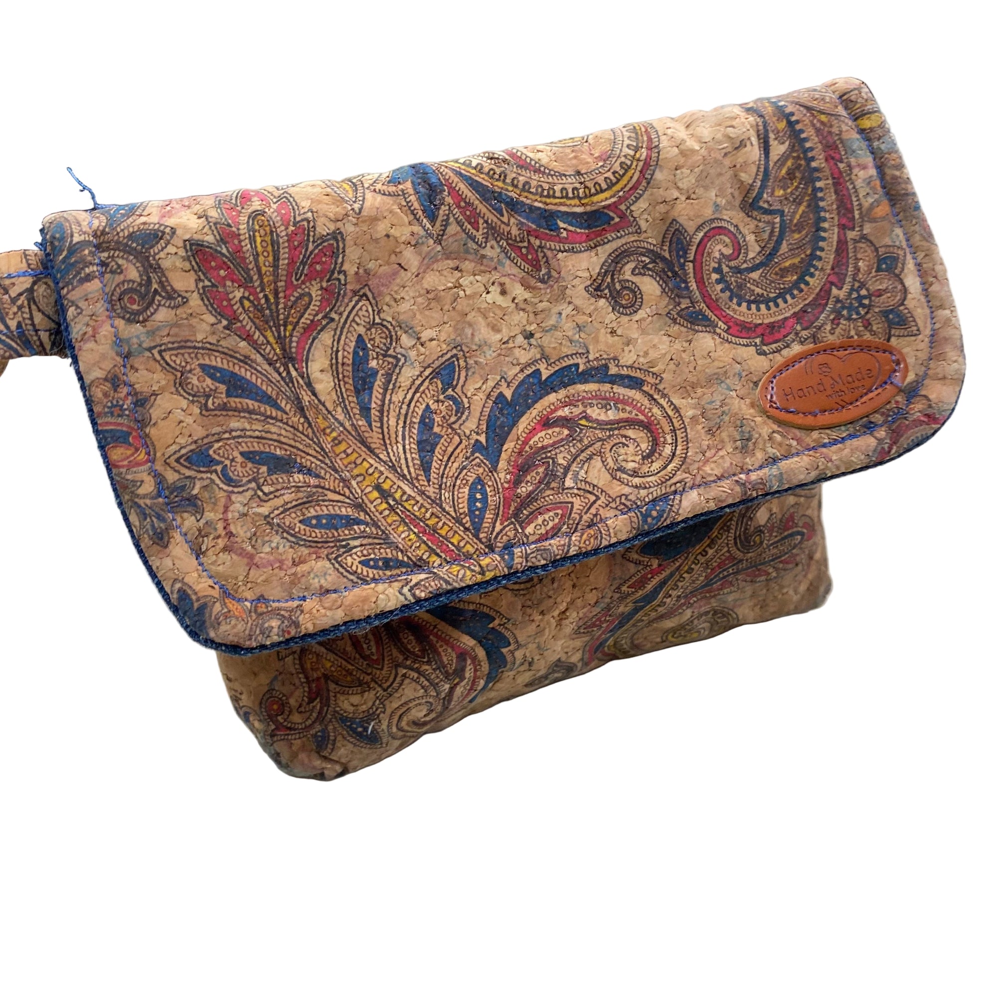 Transmutation clutch is made from recycled cork textile with paisley design. Has a small handle and is lined with denim.