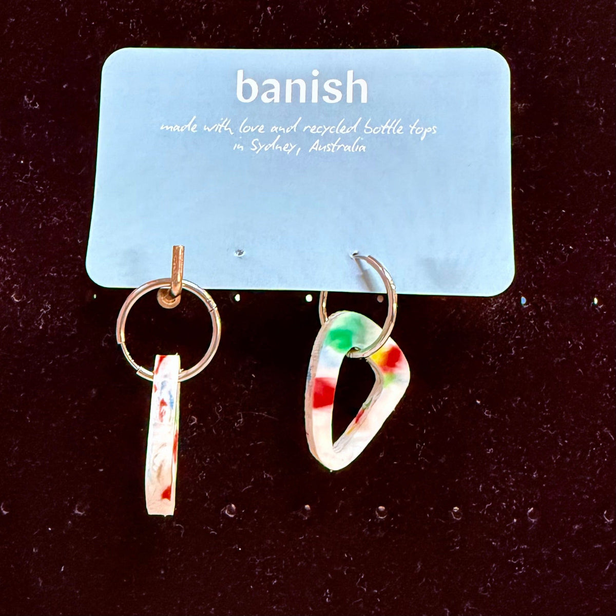 Transmutation - Earrings that are bright and colourful as a birthday cake. Made from recycling bottle tops and moulded into the shape of a sail.