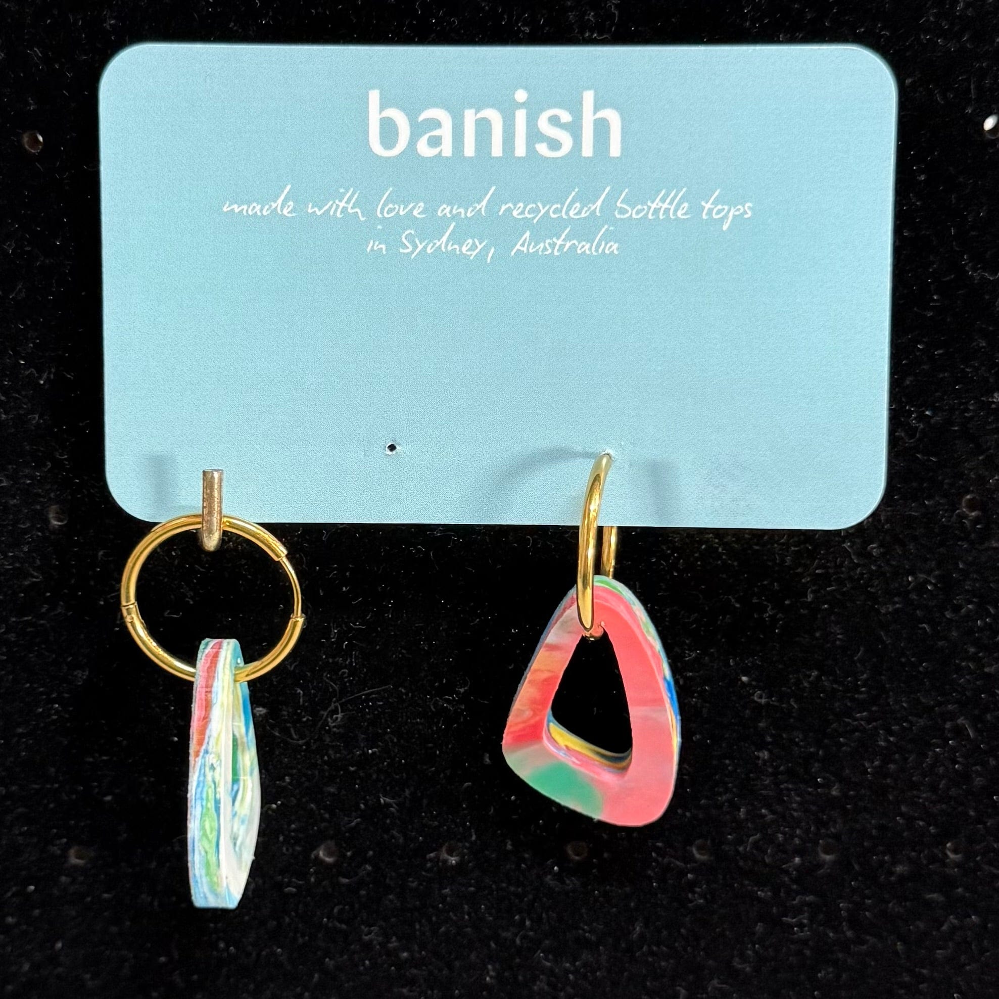 Transmutation - Earrings shaped like a sail on a yacht. A reminder to keep single use plastic out of waterways  by wearing the plastic.