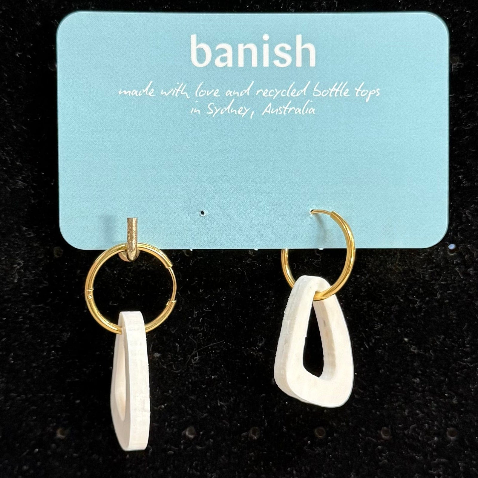 Transmutation - Earrings made from single use white as snow plastic. Madde for pierced ears with the gold hoops.