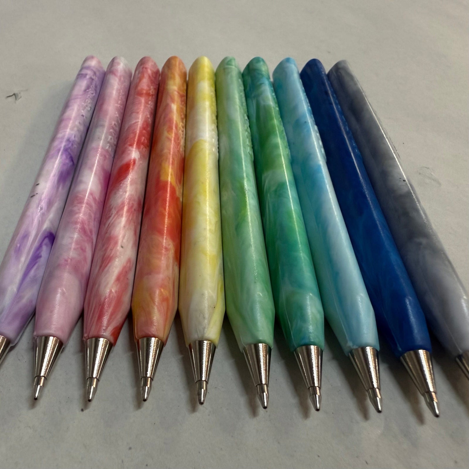 Trabnsmutation - Pens made from recycled plastic bottle tops, all colours of the rainbow with black ink.