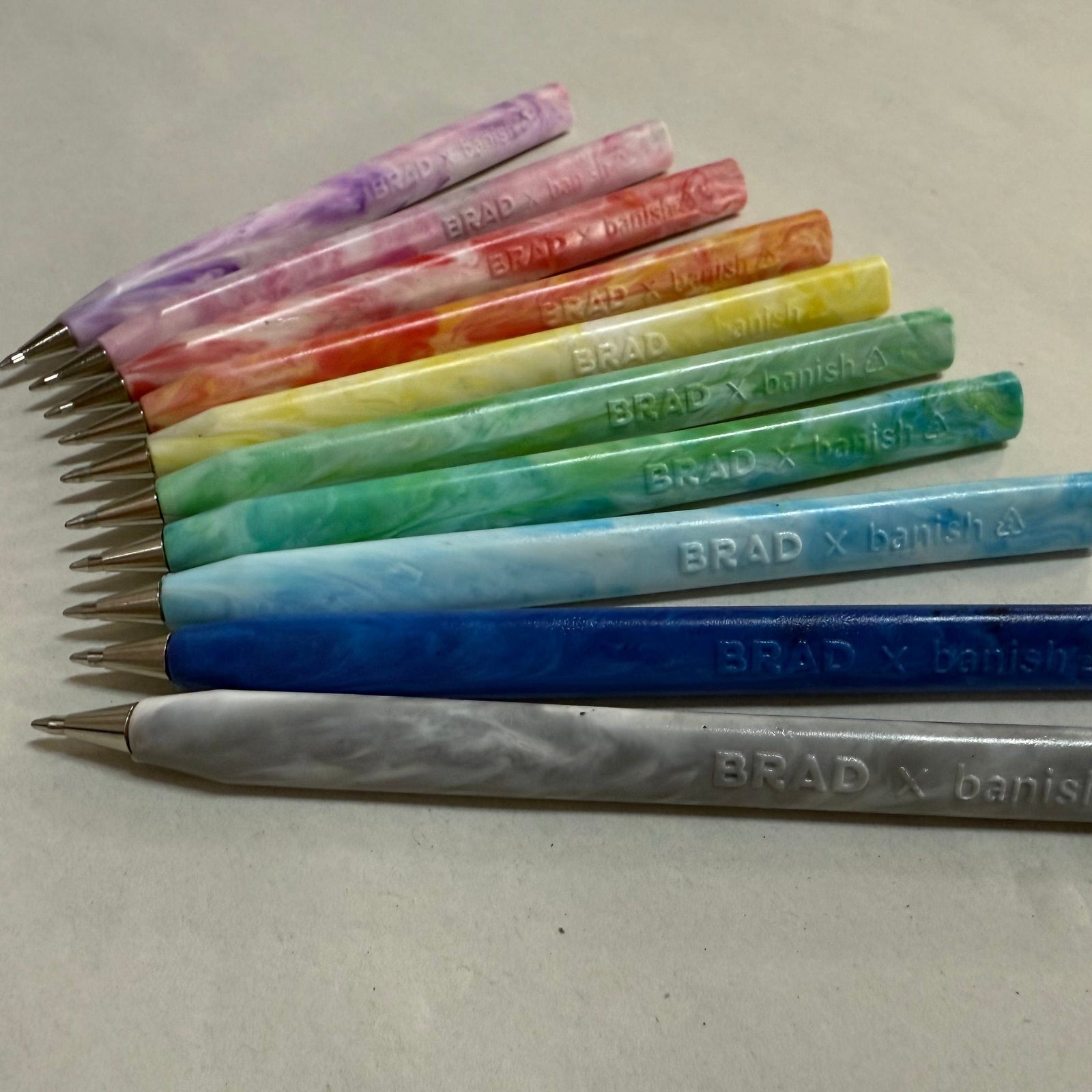 Trabnsmutation - Pens made from recycled plastic bottle tops, all colours of the rainbow with black ink.
