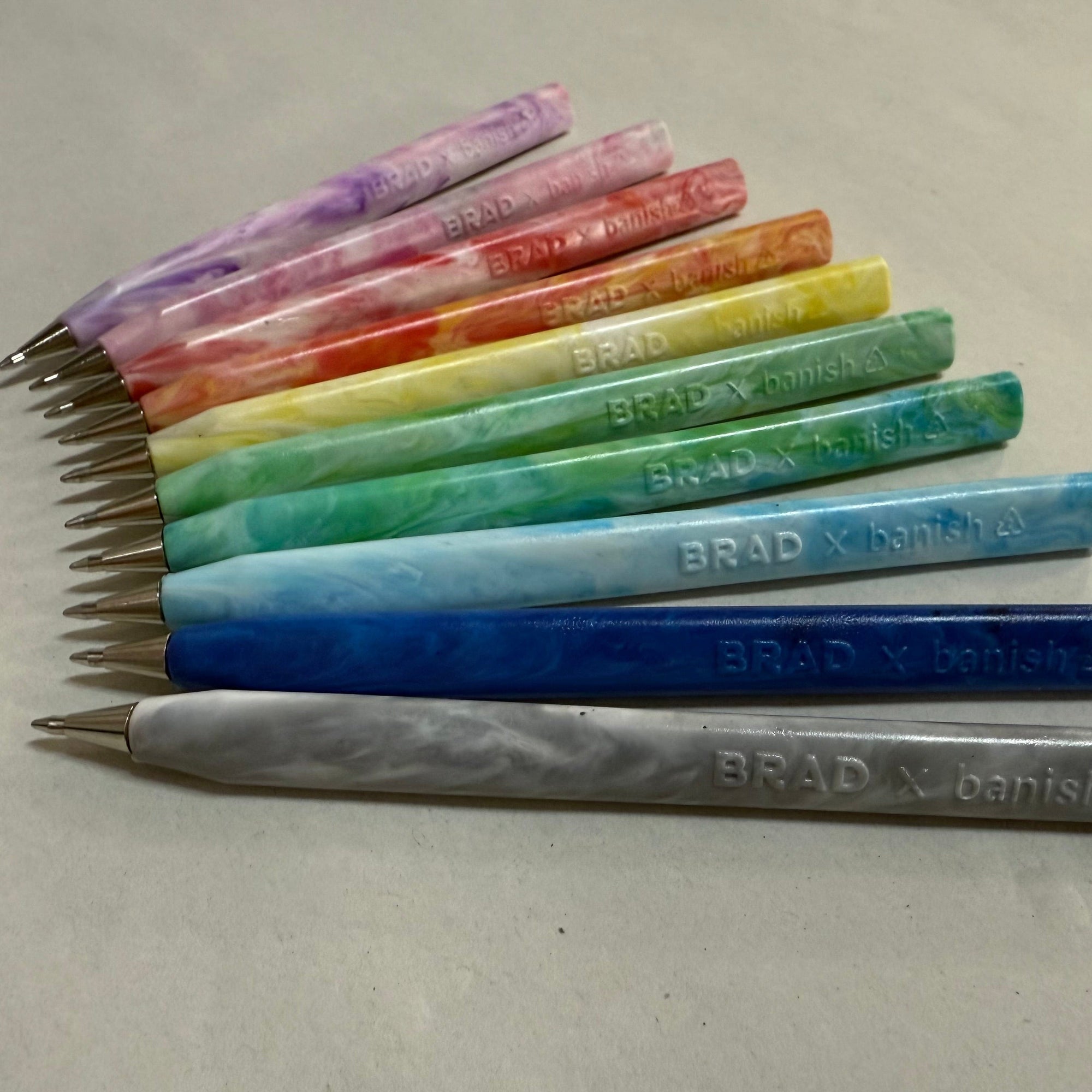 Trabnsmutation - Pens made from recycled plastic bottle tops, all colours of the rainbow with black ink.