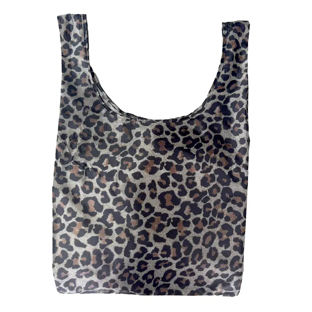 Transmutation-a yellow blue pink and white striped tote made from recycled-rPET showing vegetables in the bag.