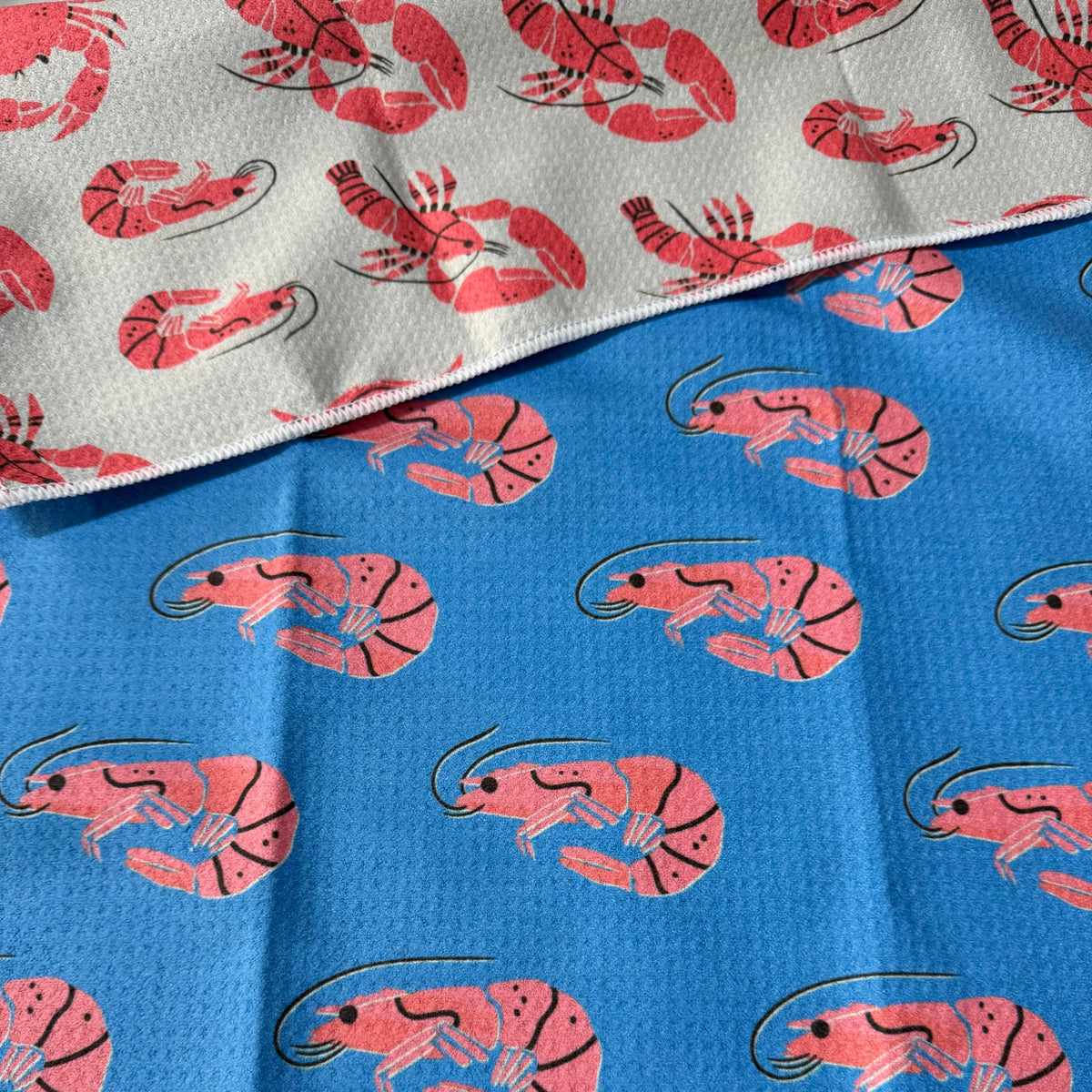 Transmutation - Handy towels by Bok Beach life have multiple uses. This design with prawns, crabs and lobster. Material is 6 plastic bottles.