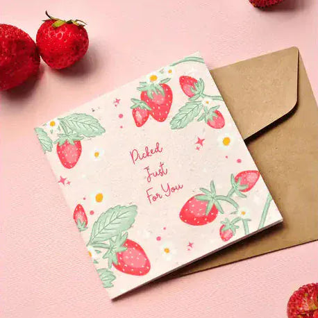Transmutation-Plantable gift cards with Strawberry Kisses design on a pink background with strawberries. Greetings - Plantable Cards.