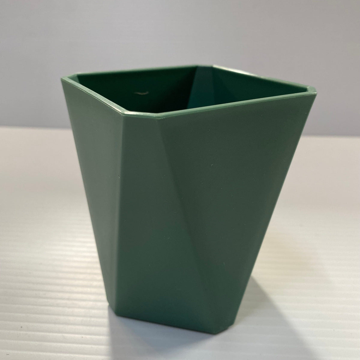 Transmutation - Geometric shaped pots made from recycled plastic and coloured sage.