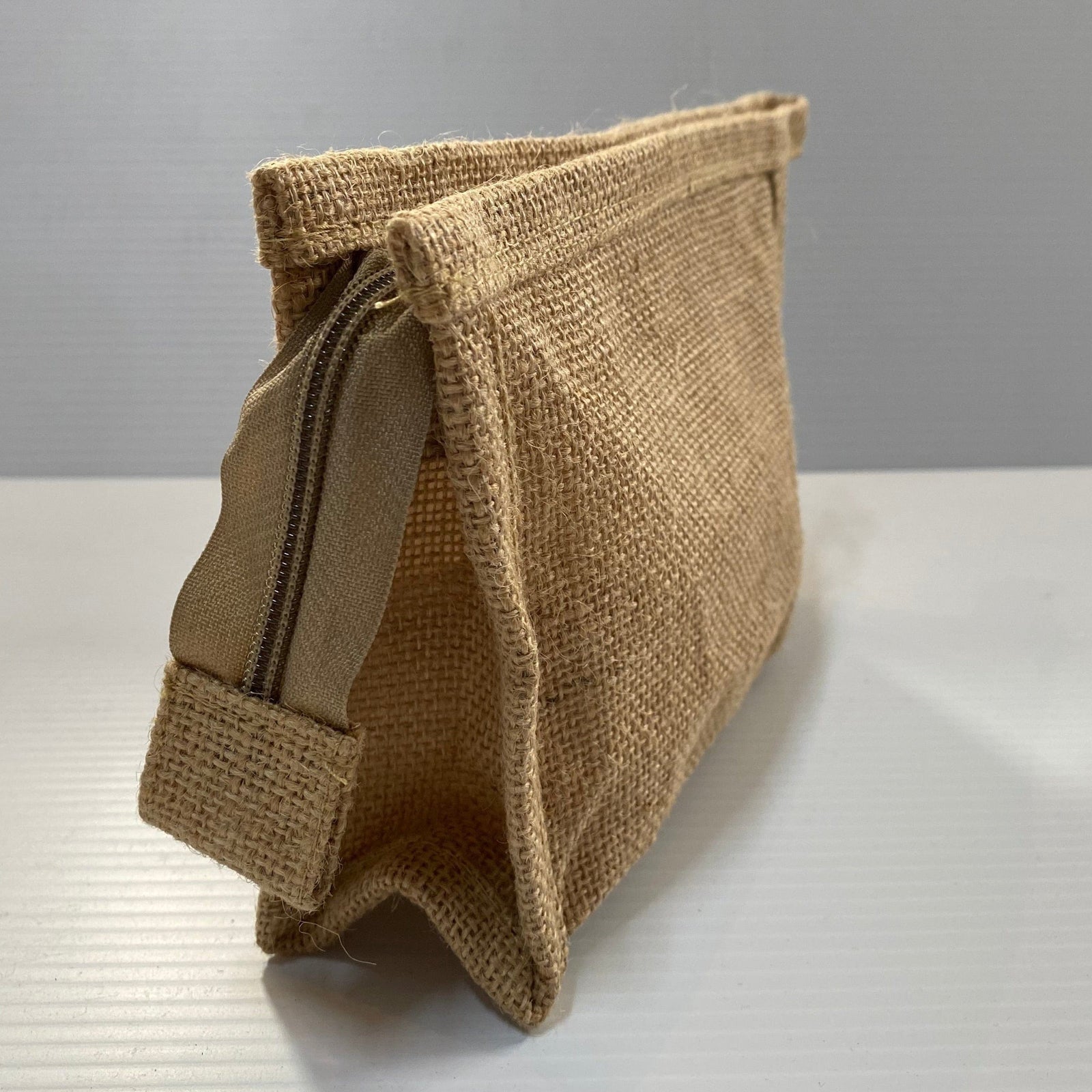 Transmutation - Bag made from sustainable jute. Lined with a water proof liner and a zipper closure. 