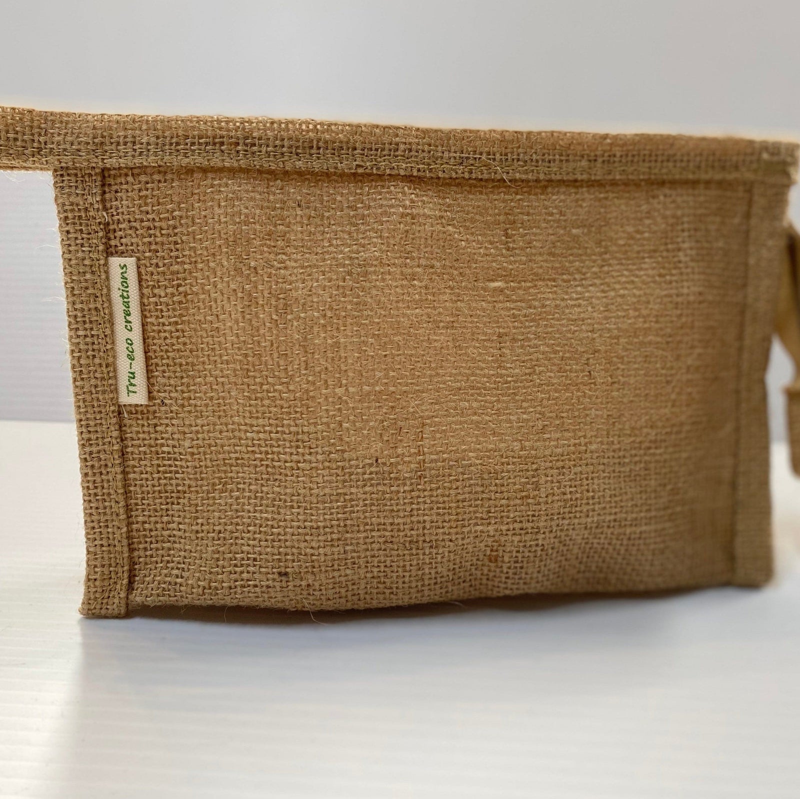 Transmutation - Bag made from sustainable jute. Lined with a water proof liner and a zipper closure. 